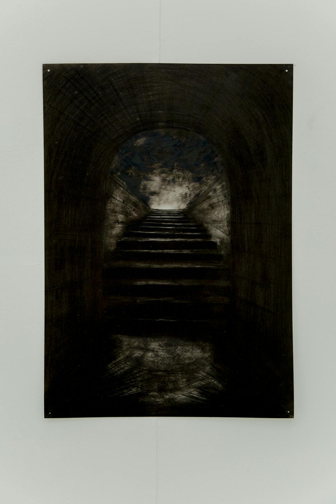 Image shows a framed shot of Yazmine's image of a black and white/grey scale tunnel or archway with some stairs behind it.